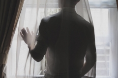 Man looking out window, 2014
